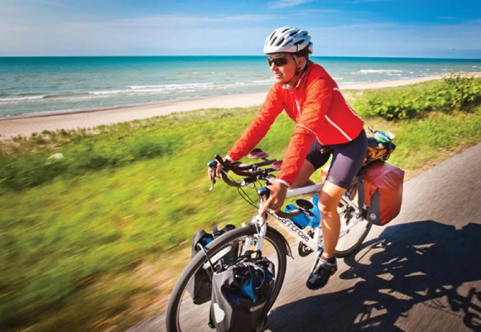 cyclist on the bike trail against the background of the sea