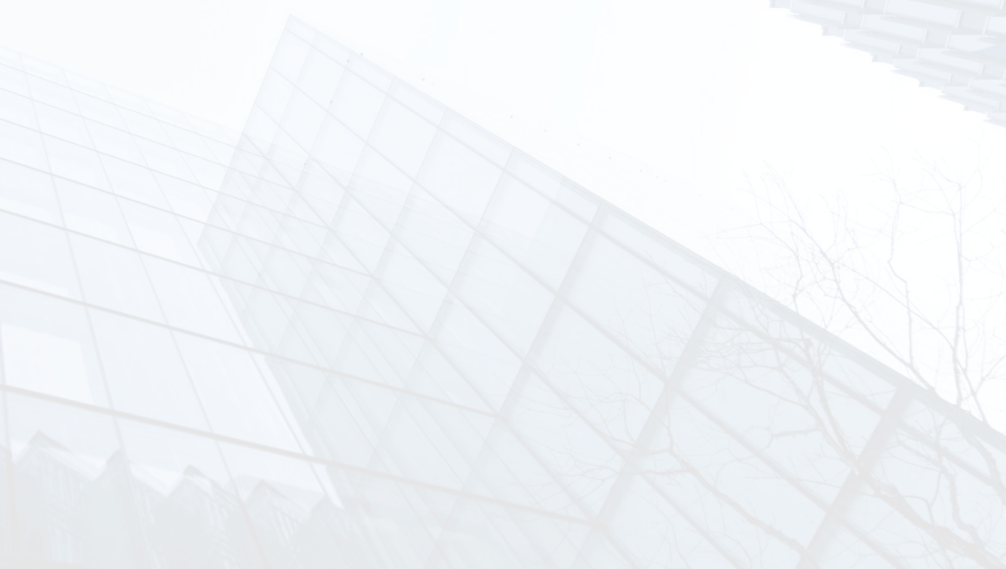 A photo of a tall glass building. The building is mostly made of glass, with a metal frame. It has a pointed roof and is surrounded by other tall buildings.